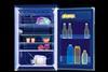 A coloured X-ray of a fridge showing the food and drinks inside and the cooling mechanism at the back