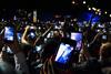People at a concert taking photos on their mobile phones