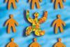 A colourful joyful figure among drab ones