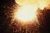 A bright explosion with sparks and smoke