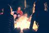 Teenagers sitting around a campfire