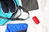 Sports clothes and a deodorant and bag laid out on a bed