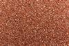 A full-frame photograph of small copper granules