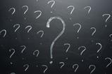Question marks on a blackboard