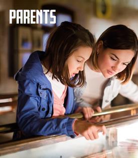 A child and adult looking at a science display