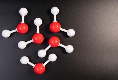 A photograph of 3D particle models illustrating molecules of water