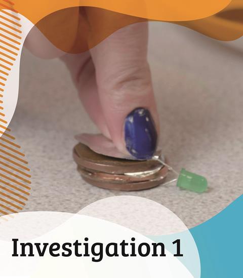 A female teacher constructs a simple coin battery using copper two pence pieces, aluminium foil and an LED